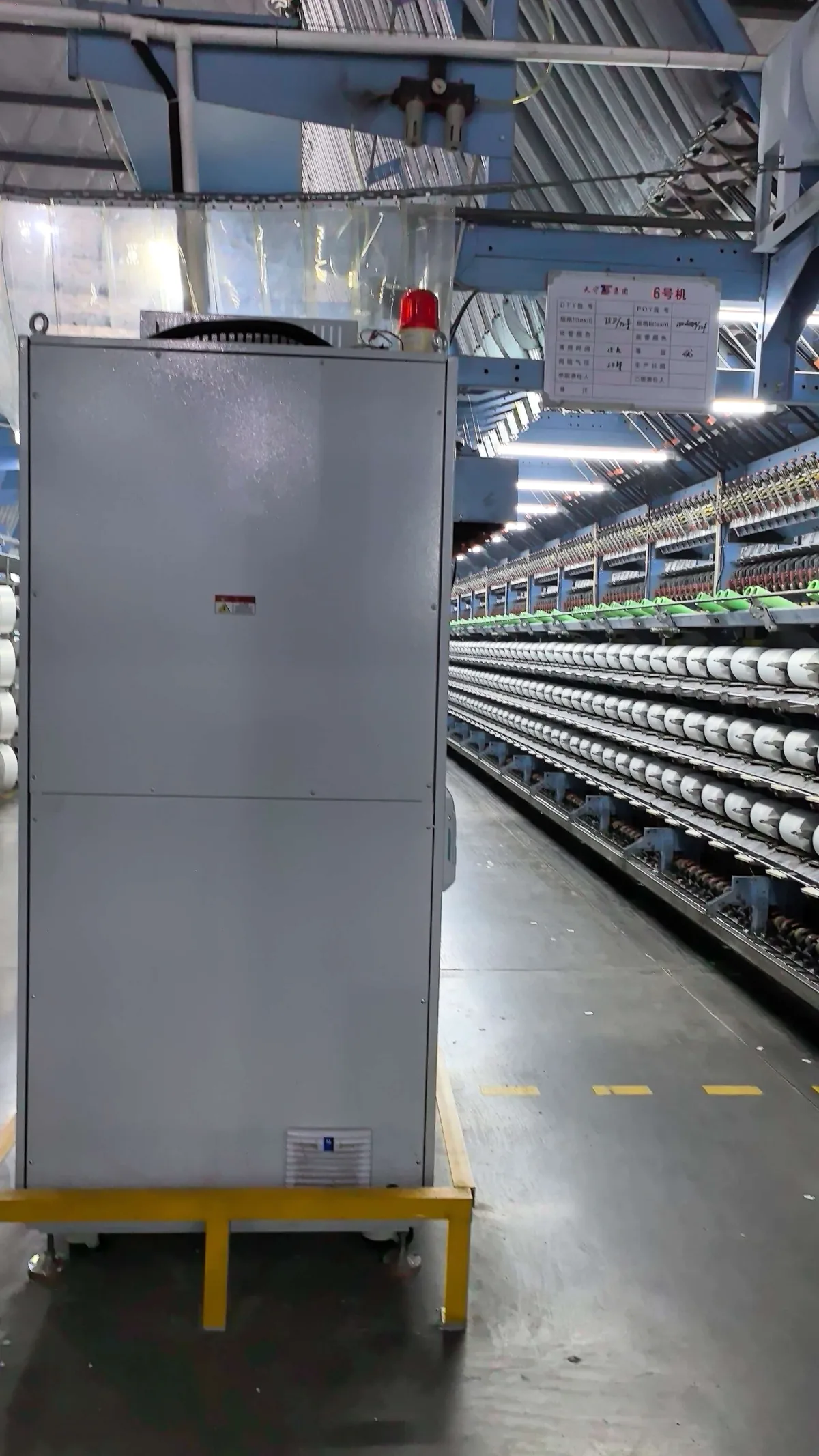 Wilson Technology power-continuity cabinet installed beside textile production equipment in Fujian, China.