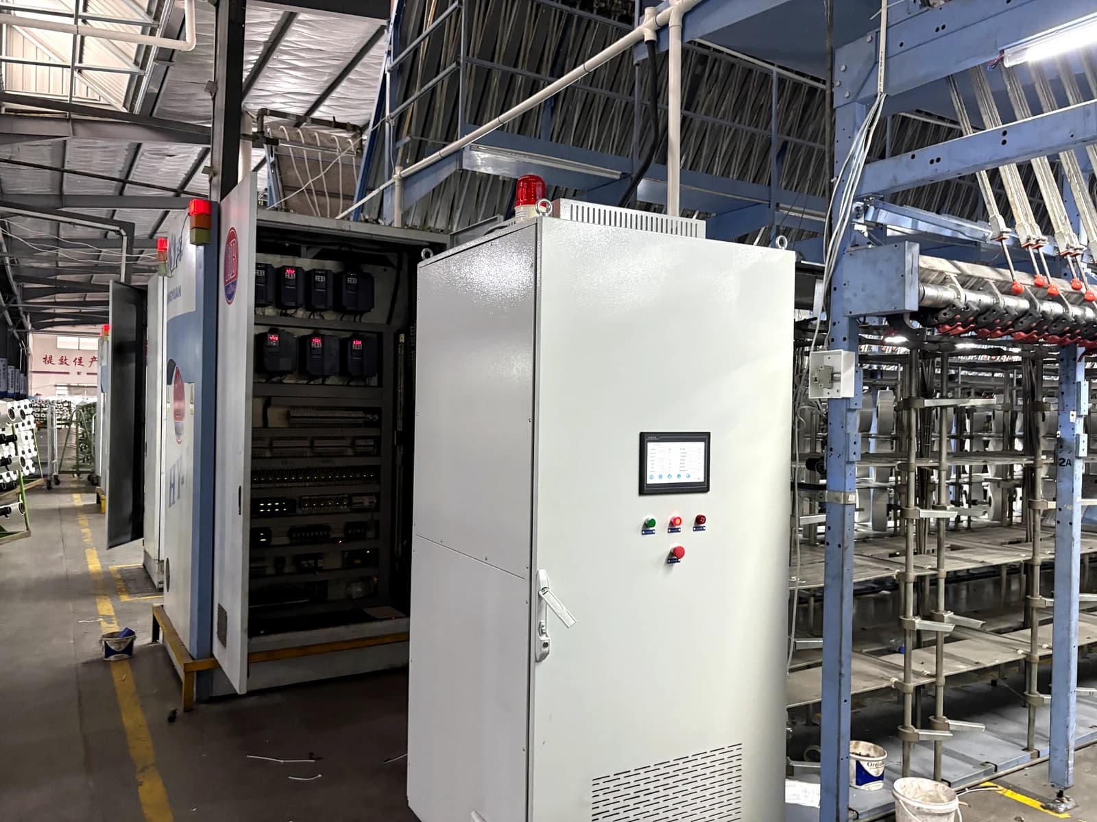 Wilson Technology WS300-66 power continuity cabinet installed beside textile production equipment in a chemical fiber plant in Fujian, China